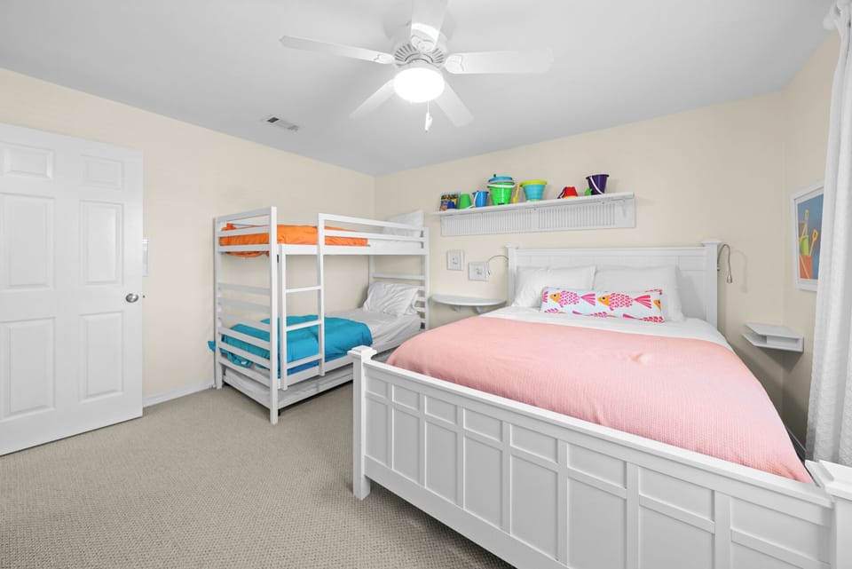 Perfect for families! Your kids will love the colorful bunk beds and spacious room with ceiling fan for comfort.