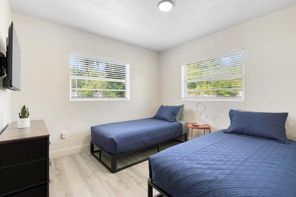 Bedroom 2: 2 single beds with tv, chest of drawers and plenty of light.