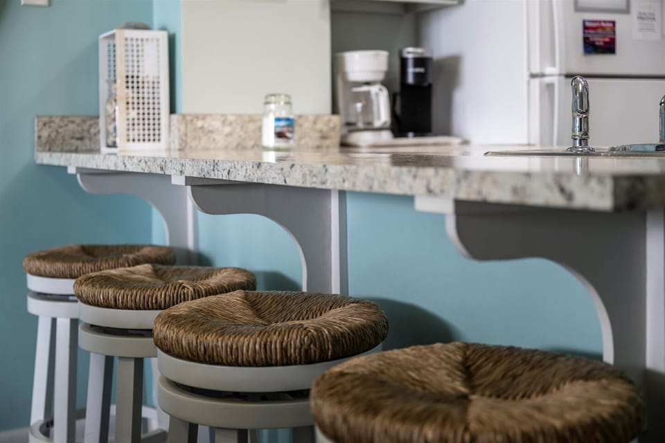 Start your morning with a coffee and ocean breeze at this cozy bar-height counter with woven stools.
