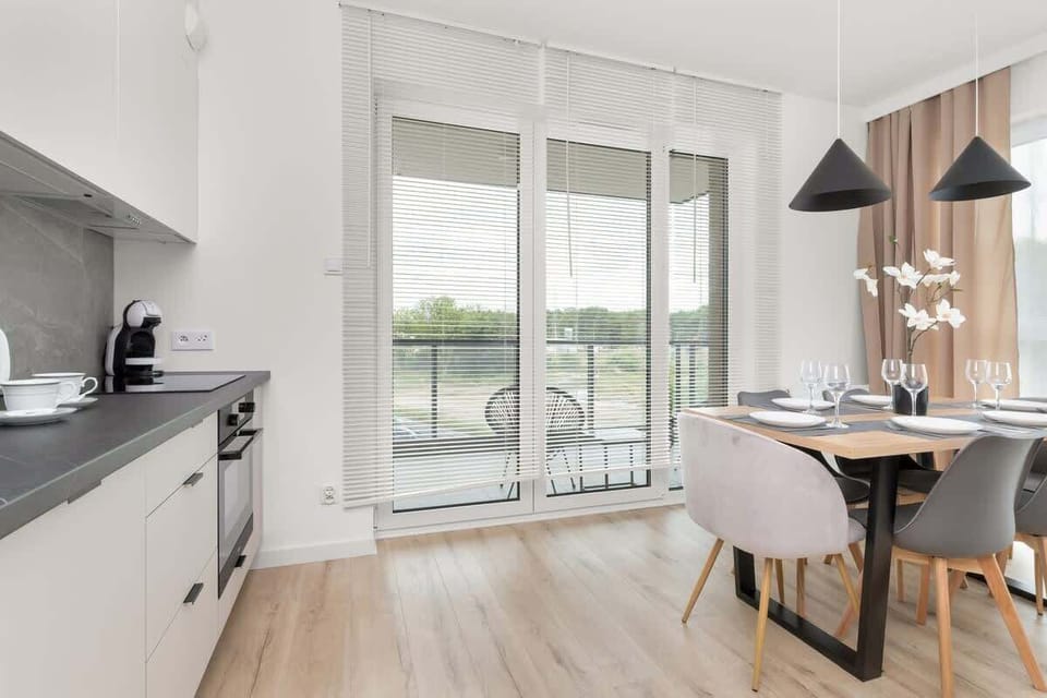 The dining area connected to the kitchen opens onto the balcony, offering a harmonious space for gatherings and meals.