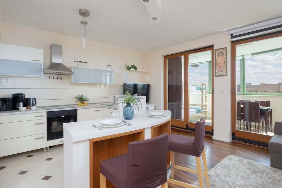 The sleek design of the kitchenette blending seamlessly with the living area.