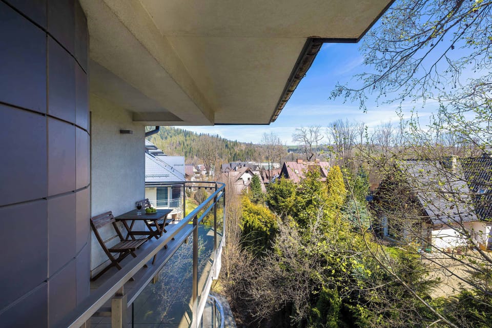 A unique balcony with garden furniture and views of the surrounding area.