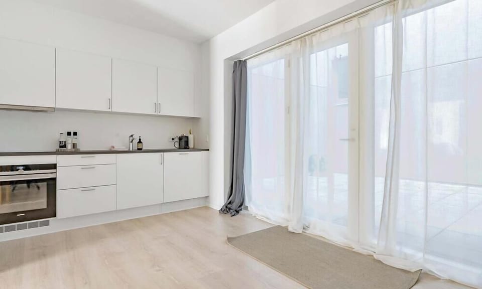 Entrance to the apartment with double-curtains (Thin curtains and blackout curtains). The entrance-area outside is fully private and can only be accessed by residents of the property.
