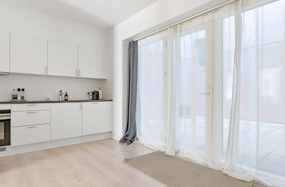 Entrance to the apartment with double-curtains (Thin curtains and blackout curtains). The entrance-area outside is fully private and can only be accessed by residents of the property.