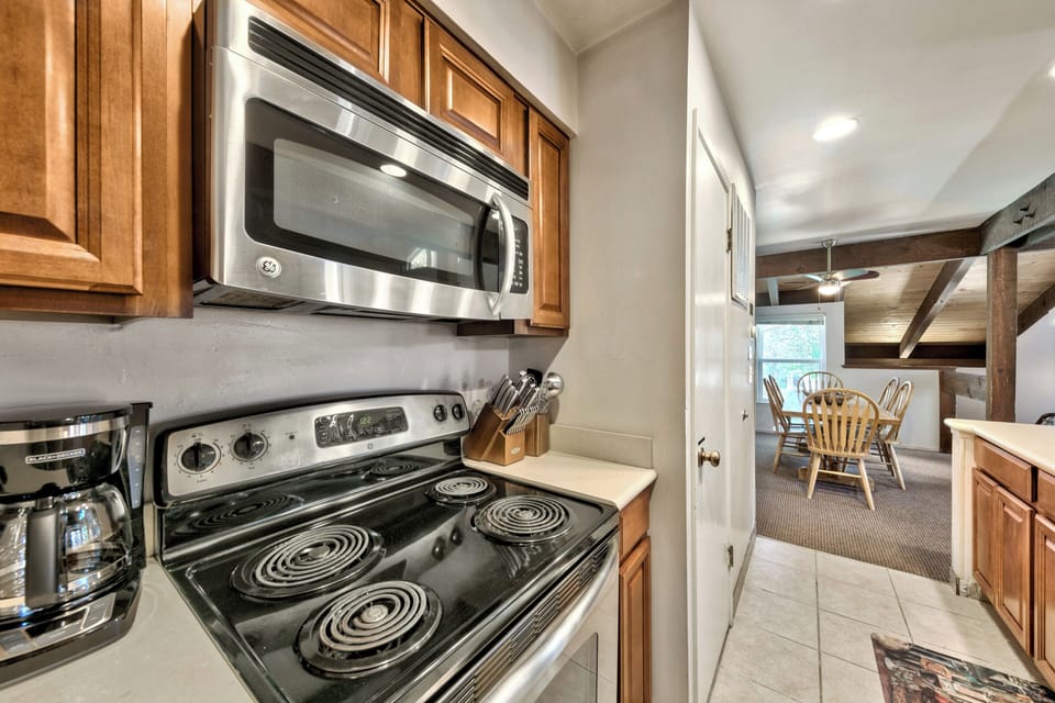 Your fully equipped kitchen awaits with stainless steel appliances and warm wood cabinetry, perfect for preparing meals during your stay.