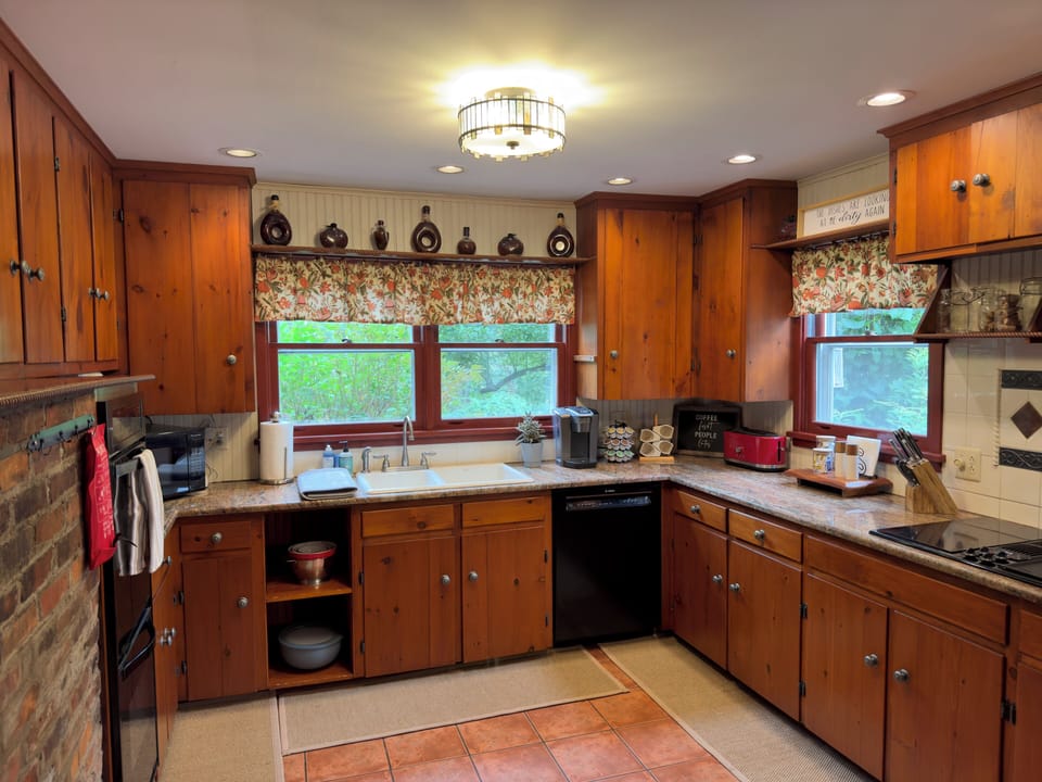 Enjoy cooking and dining in this fully stocked country kitchen, complete with all appliances, ample counter space, and all the essentials for a seamless culinary experience.