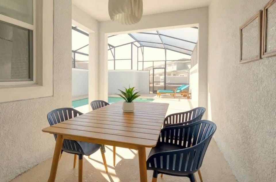 Patio with table and chairs for dining.
