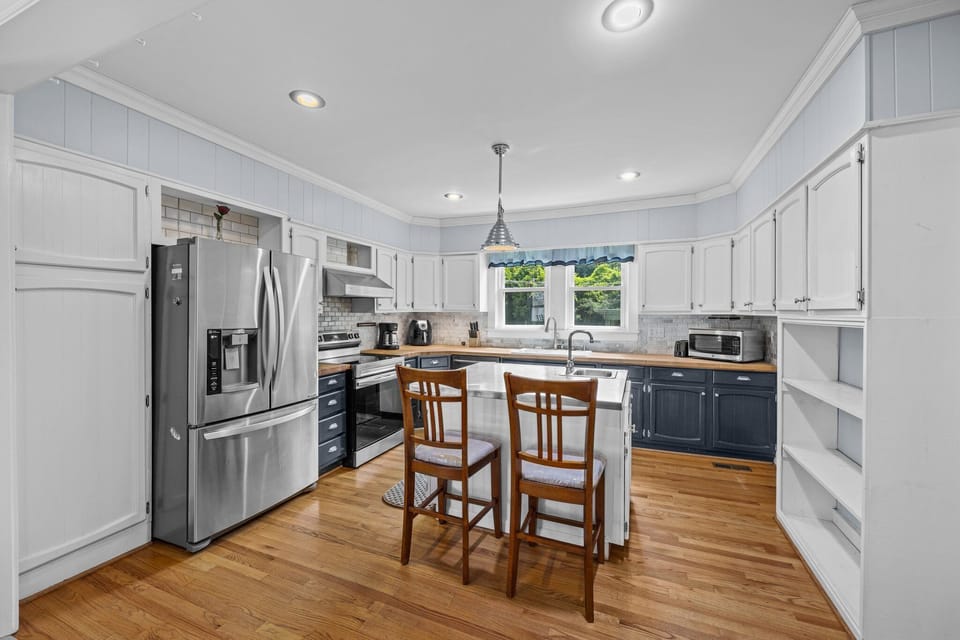 Modern kitchen with stainless steel appliances and ample seating