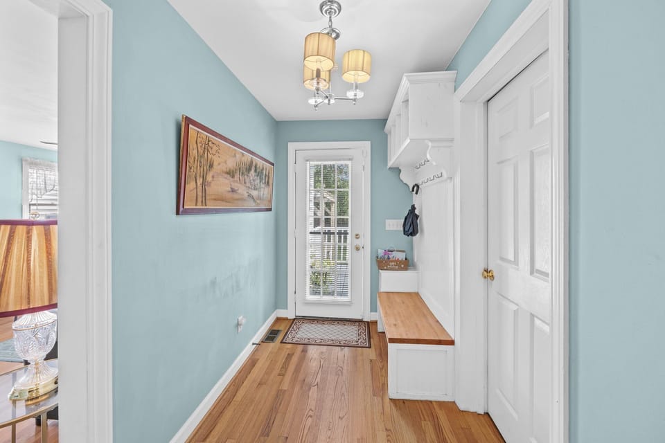 Functional mudroom with a door leading to the back deck