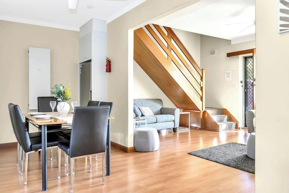 Enjoy snacks or large feasts at a comfortable central dining table with black leather chairs. 