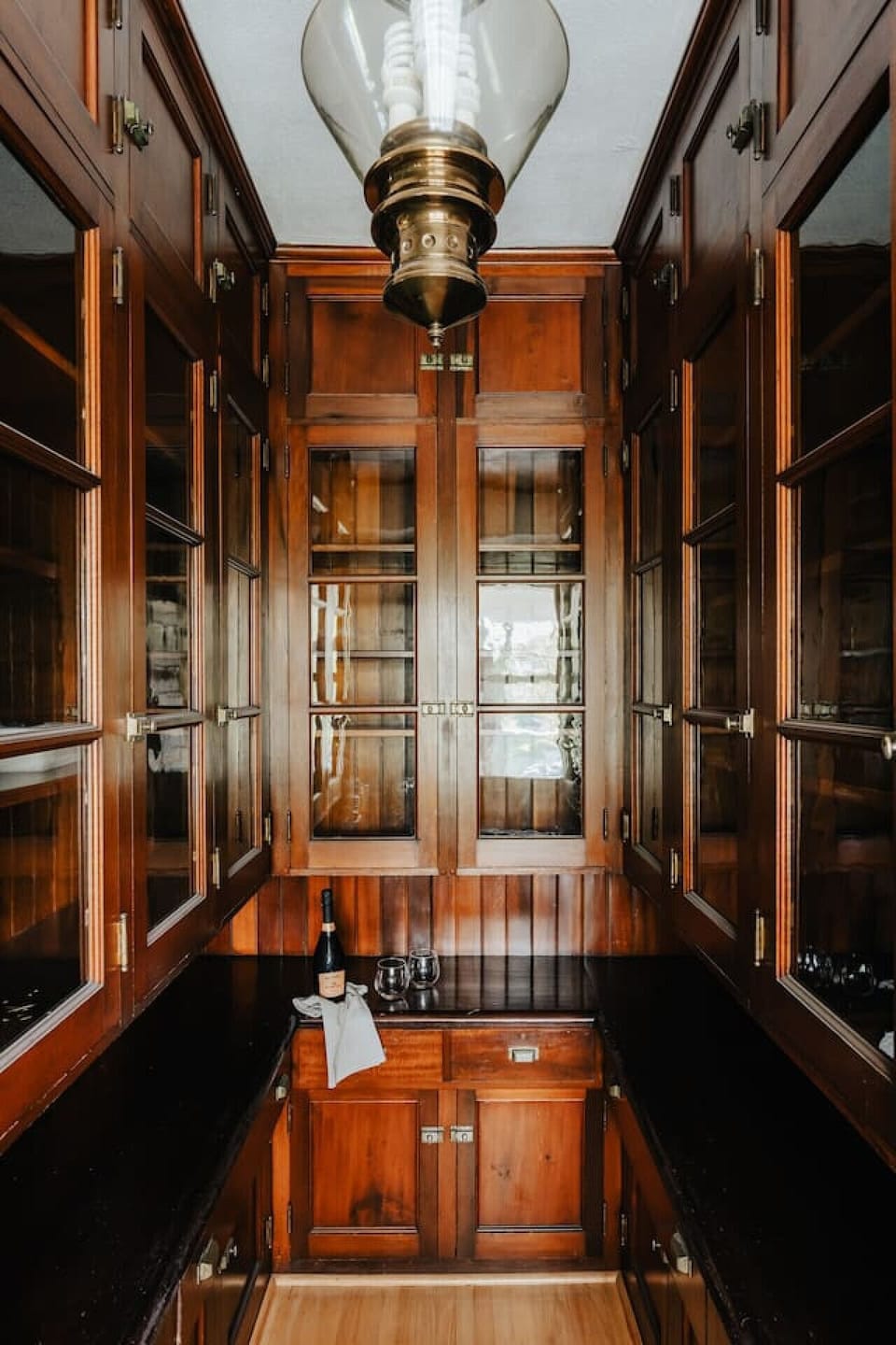 A glimpse into the butler’s pantry, showcasing rich wood craftsmanship and a touch of historic charm.