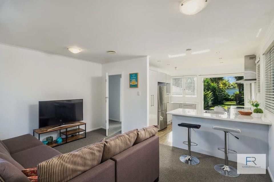Living area with large couch and heat pump