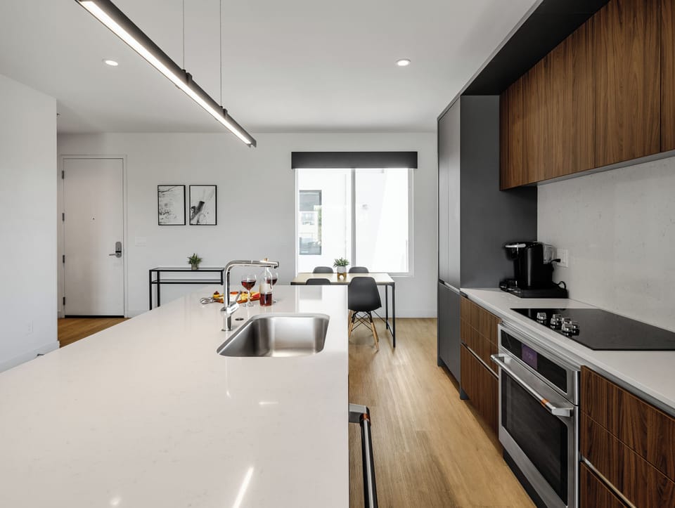 Unit 1 (1st Floor): Fully equipped modern kitchen completely stocked with all culinary essentials and includes high-end Cafe stainless steel appliances. Dining table offers a space for four.