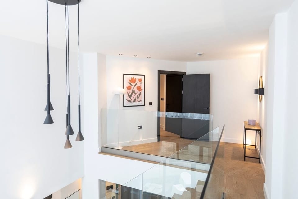 Ground floor entrance with a staircase leading down to the open-plan living area.
