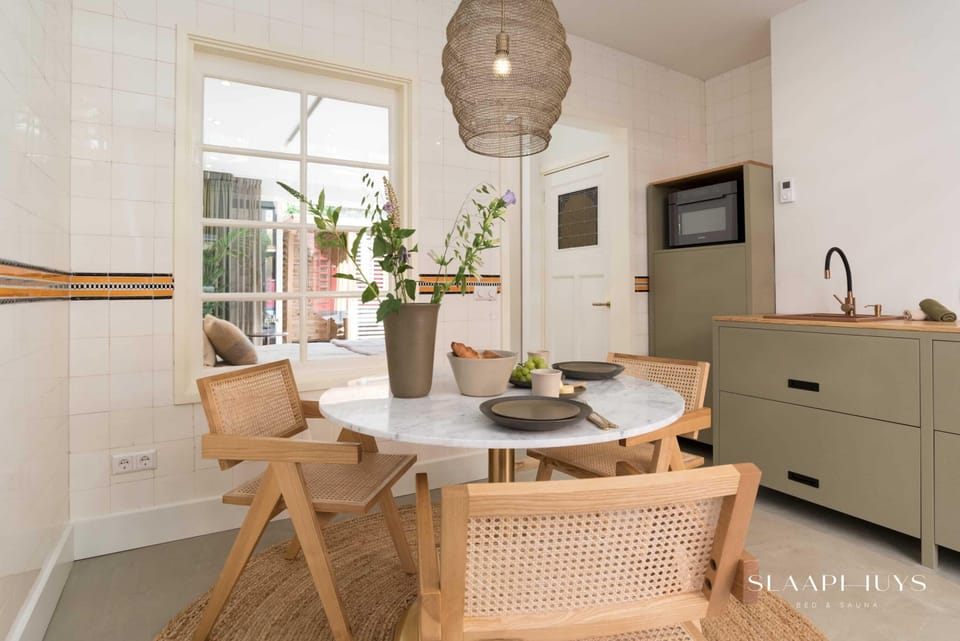 Stylish kitchen and dining area with warm wood details and natural light — perfect for enjoying a slow breakfast or sharing a meal together.