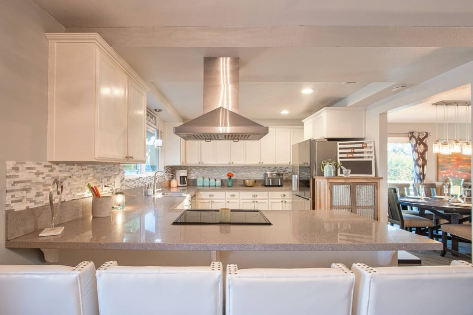 Exhaust hood by the stove at the kitchen to remove fumes, smoke, heat, and steam from the air from cooking.