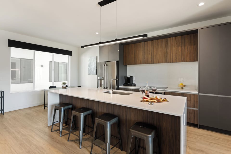 Unit 1 (1st Floor): Fully equipped modern kitchen completely stocked with all culinary essentials and includes high-end Cafe stainless steel appliances. Dining table offers a space for four.