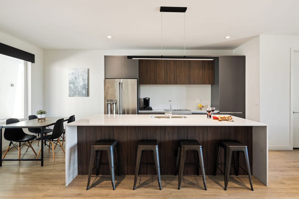 Unit 1 (1st Floor): Fully equipped modern kitchen completely stocked with all culinary essentials and includes high-end Cafe stainless steel appliances. Dining table offers a space for four.