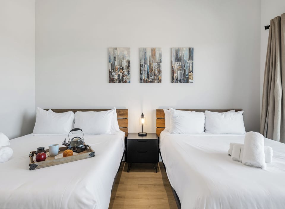 Unit 2 - 2nd Floor: Primary Bedroom featuring 2 Queen Beds, a Smart TV, a private balcony, and an ensuite primary bathroom.