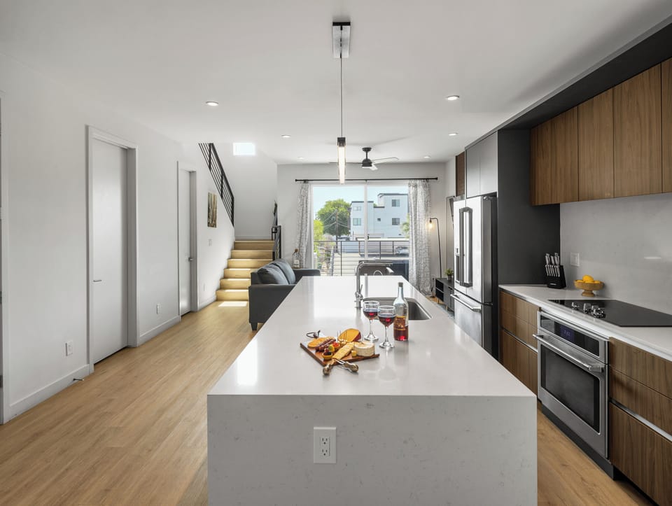 Unit 1 (1st Floor): Fully equipped modern kitchen completely stocked with all culinary essentials and includes high-end Cafe stainless steel appliances. Dining table offers a space for four.