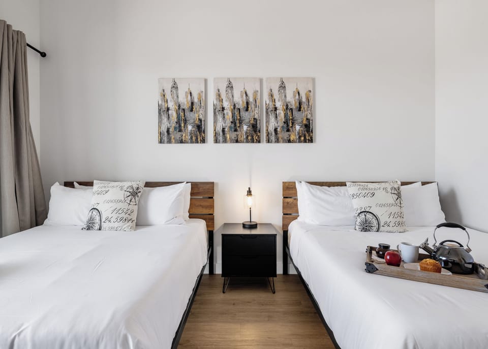 Unit 2 (2nd Floor): Primary Bedroom featuring 2 Queen Beds, a Smart TV, a private balcony, and an ensuite primary bathroom.