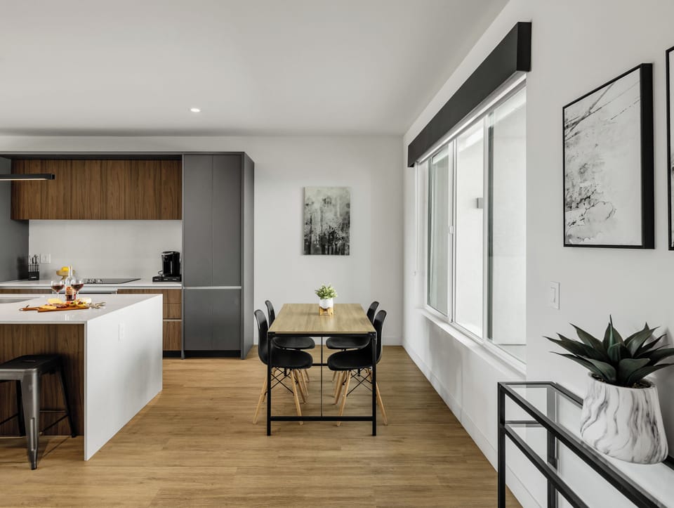 Unit 1 (1st Floor): Fully equipped modern kitchen completely stocked with all culinary essentials and includes high-end Cafe stainless steel appliances. Dining table offers a space for four.