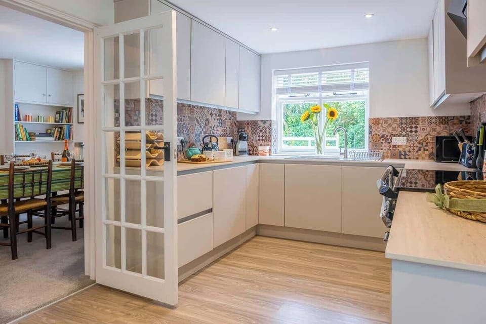 The beautifully equipped kitchen, complete with a dishwasher, microwave, washer/dryer, and a full set of glasses, cutlery, and plates, makes meal preparation a delightful experience.