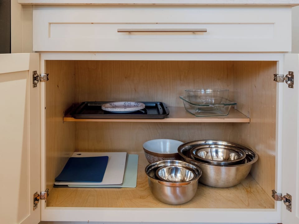 Bowls and cutting boards. Pots and pans are in the opposite cupboard.