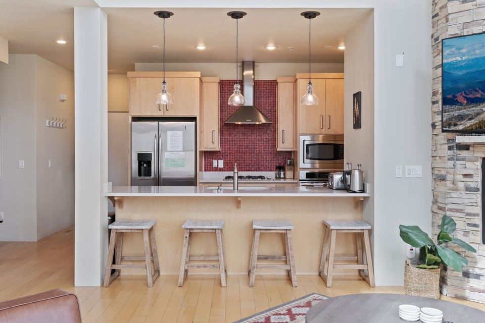 The kitchen has an island counter with chairs, ideal for enjoying breakfast or a quick snack! | The Hillside, Brian Head, Utah | Voyax Luxury Vacation Rentals