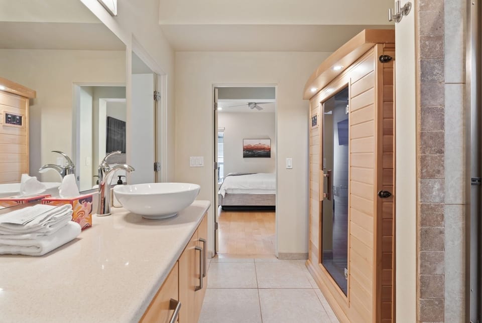 This bedroom features a bathroom with a sauna/steam room and a shower/tub combo for ultimate relaxation! | The Hillside, Brian Head, Utah | Voyax Luxury Vacation Rentals