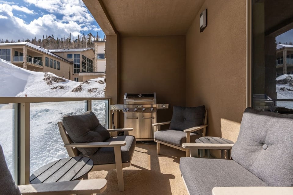 The first-floor balcony features seating and a grill, making it a great spot for outdoor dining and relaxation! | The Hillside, Brian Head, Utah | Voyax Luxury Vacation Rentals