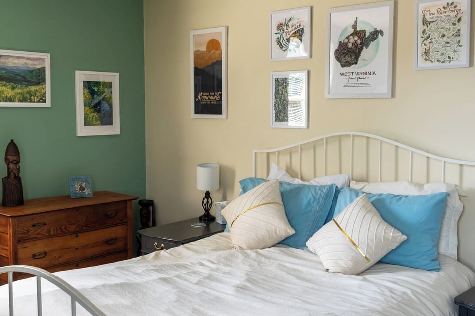 WV Artist room has a comfortable queen bed and plenty of storage. 