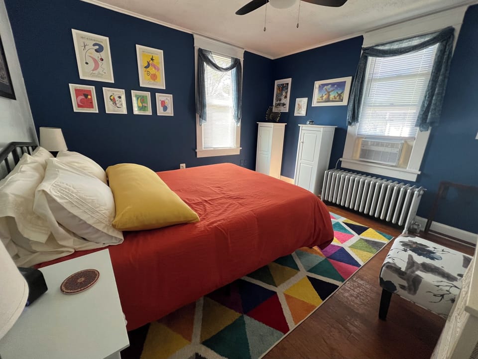 The Spanish room features art from iconic artists, a queen size bed and ironing.