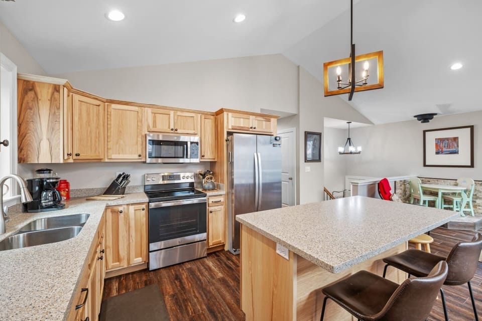 Flat top electric range, island for extra countertop space, open floor plan to stay included