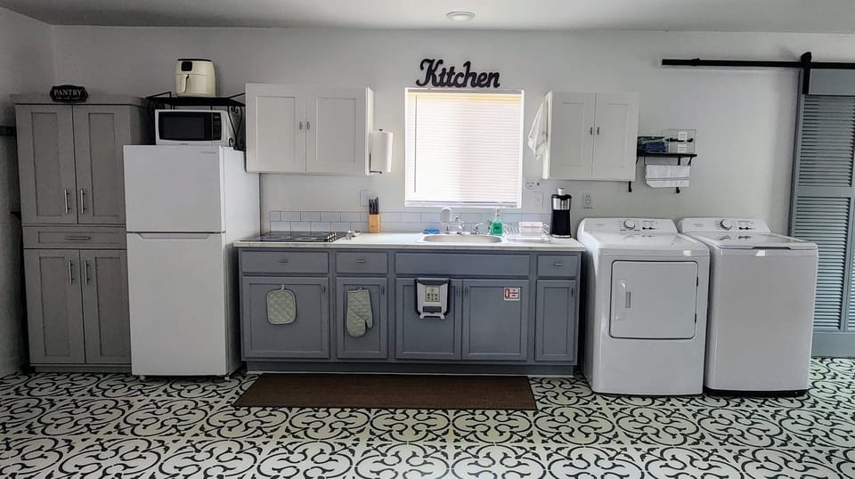 Fully equipped kitchen with appliances, cookware and utensils.