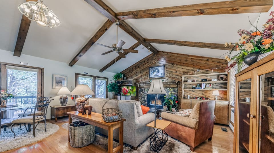 Second living room with wood burning fireplace and TV