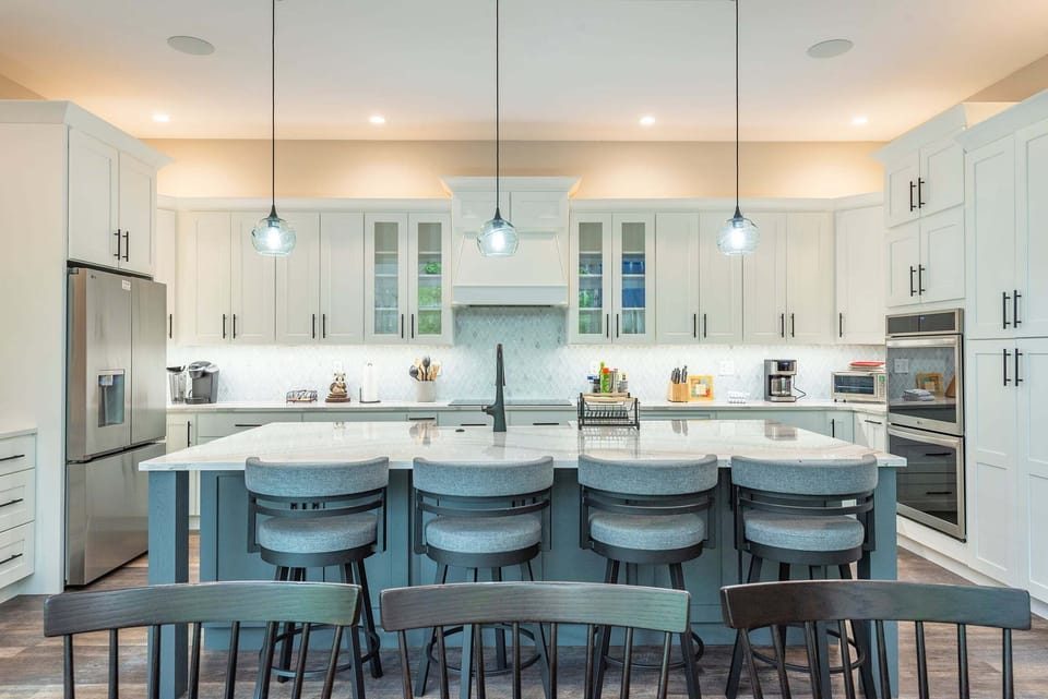 Deluxe chef's kitchen with high-end appliances, double oven, dishwasher, wine cooler, and Drip-style coffeemaker