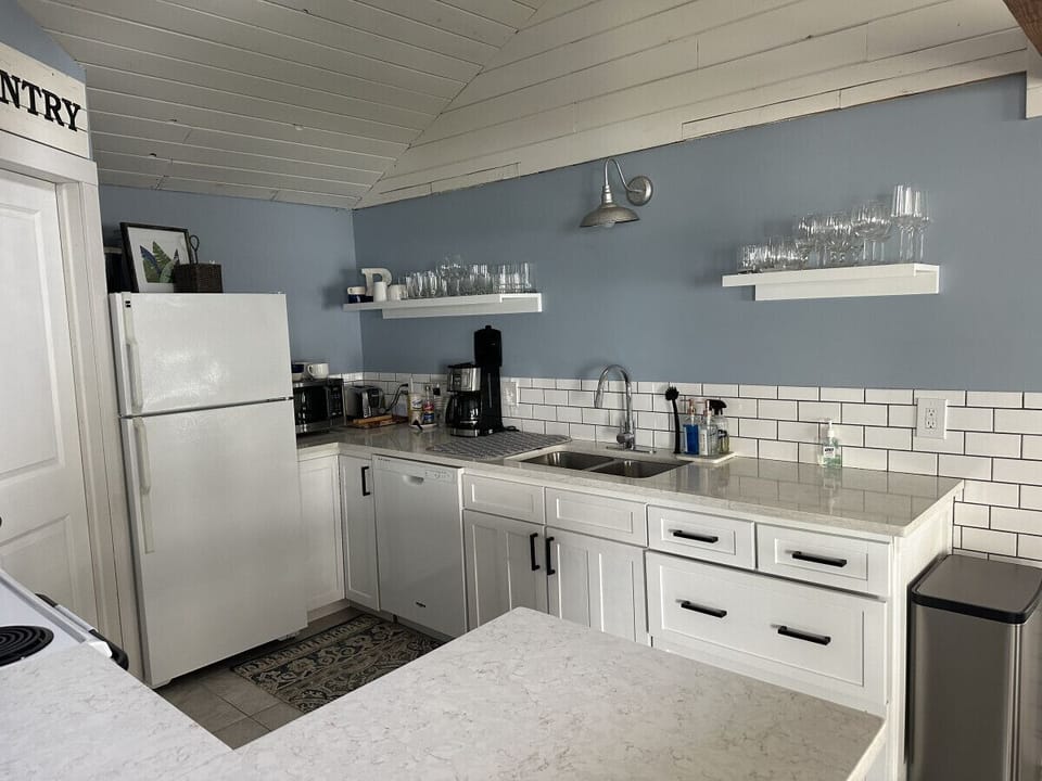 Kitchen highlights include seating for 6, a Keurig coffee machine with provided pods, a dishwasher, complimentary pure spring water dispenser, a microwave, a toaster oven, and plenty of various baking dishes, utensils, and spices.