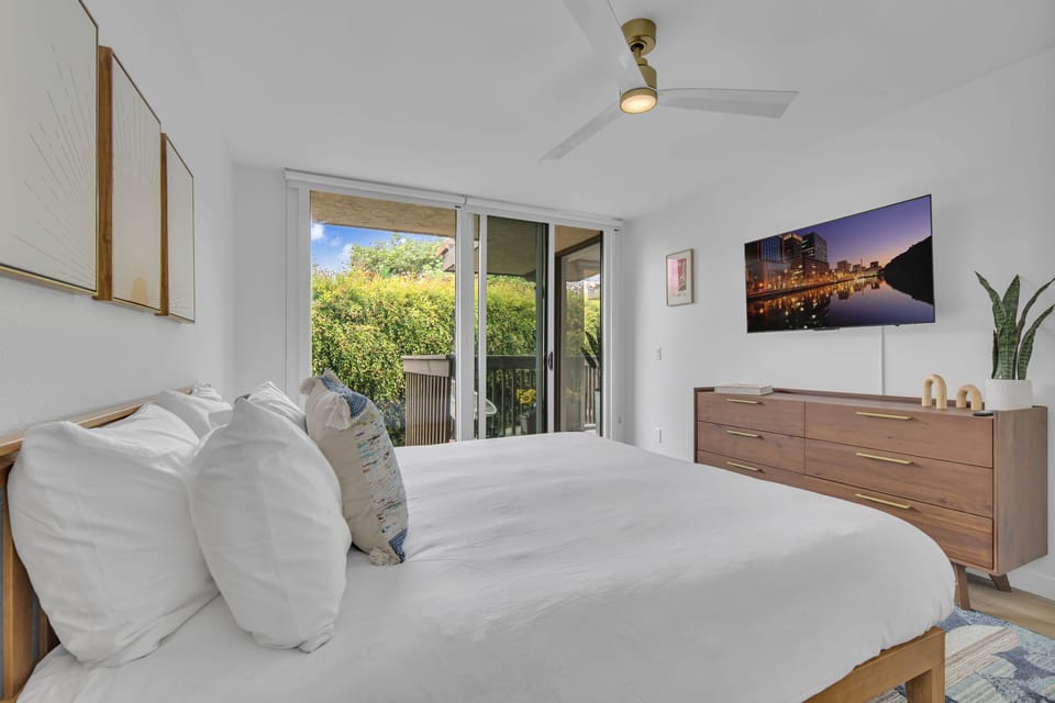 Guest bedroom: king bed, desk & chair for remote working, small private balcony, smart TV, walk-in closet