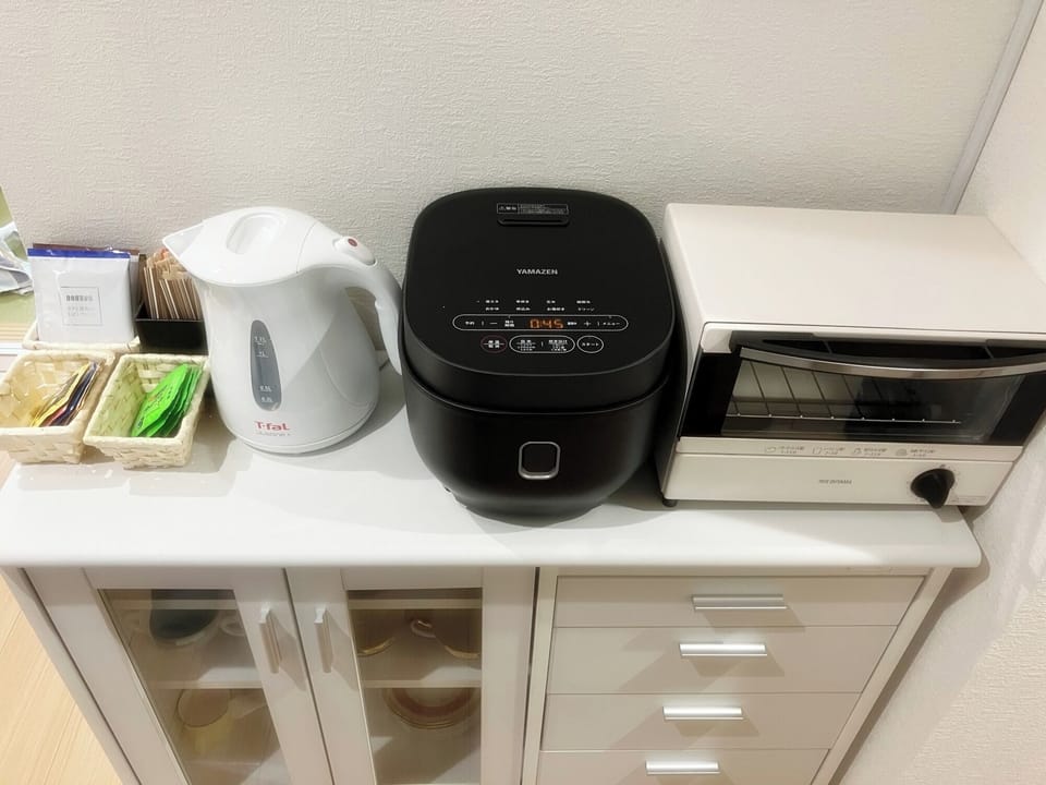 A kettle, rice cooker, and toaster oven.