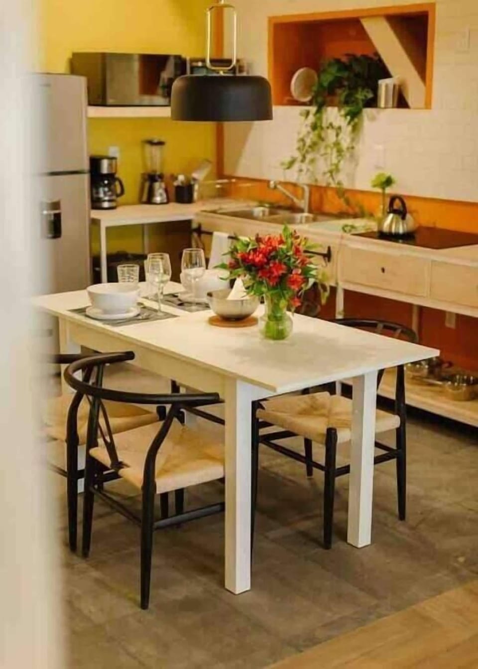 enjoy a meal in this dining room with a fully equipped kitchen