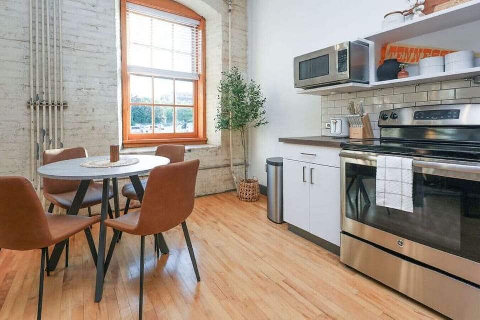 Dining Area: Enjoy meals in style with natural light and modern decor in the heart of Knoxville!