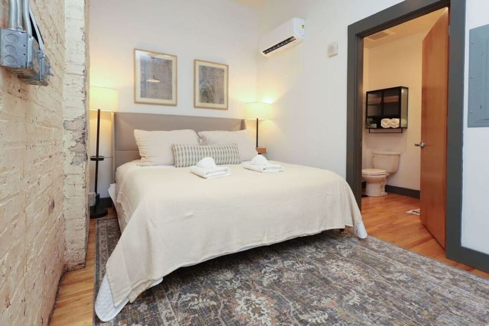 Bedroom Retreat: Relax in this stylish space with warm lighting and inviting decor for your getaway!