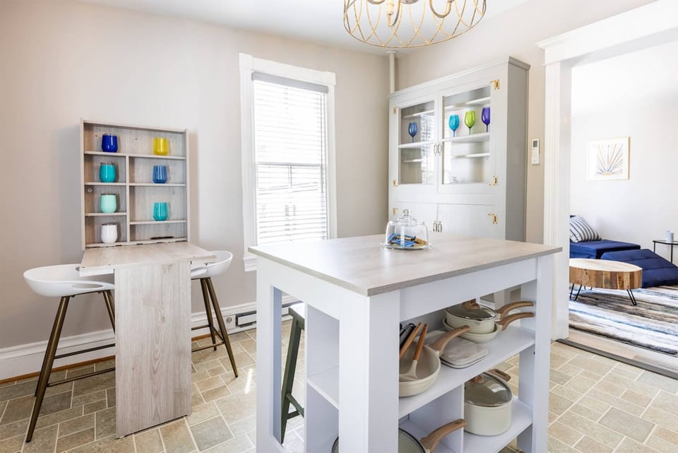 The kitchen is fully stocked with cookware, dinnerware and barware.