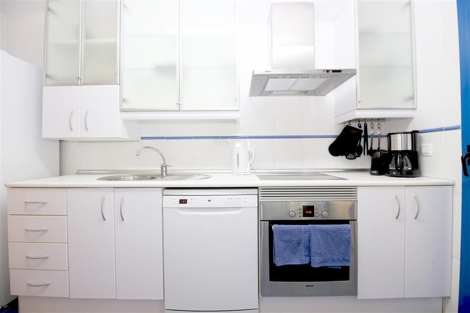 Kitchen in this apartment is fully fitted with all the appliances