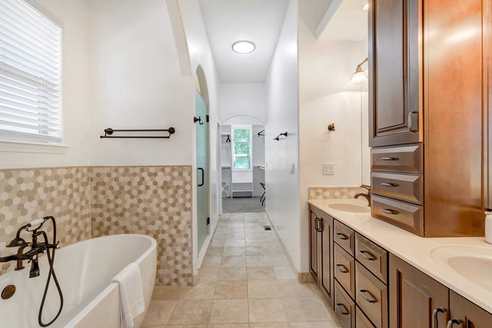 Luxurious master bathroom with a soaking tub, dual sinks, and a spacious walk-in shower.