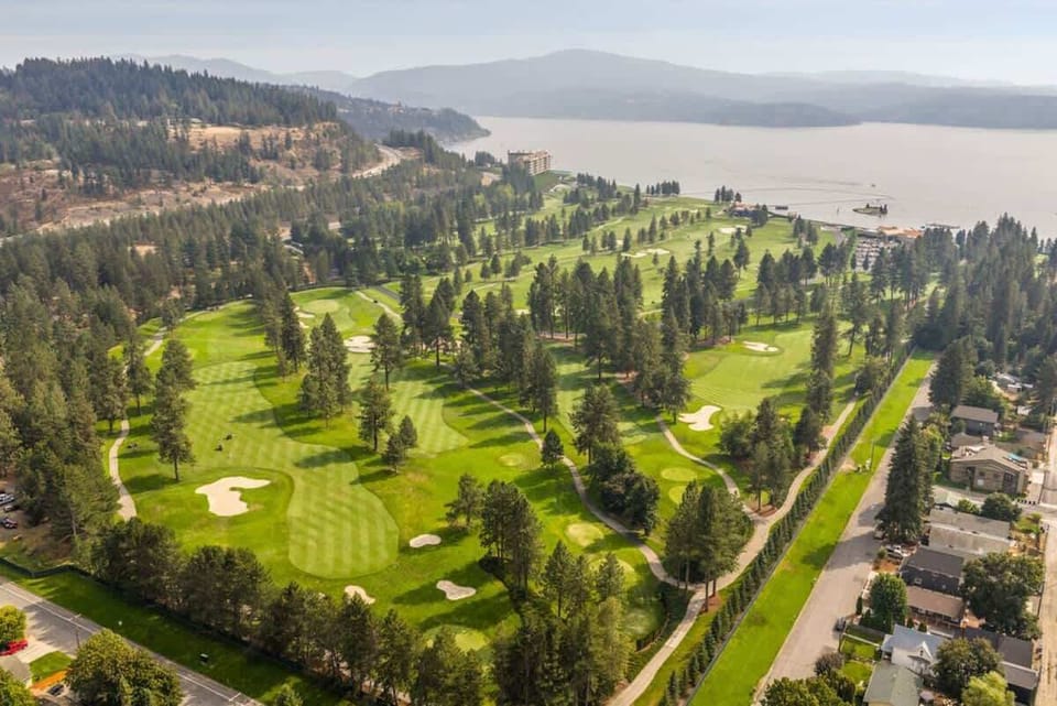 Scenic greens surrounded by mountains and the lake.