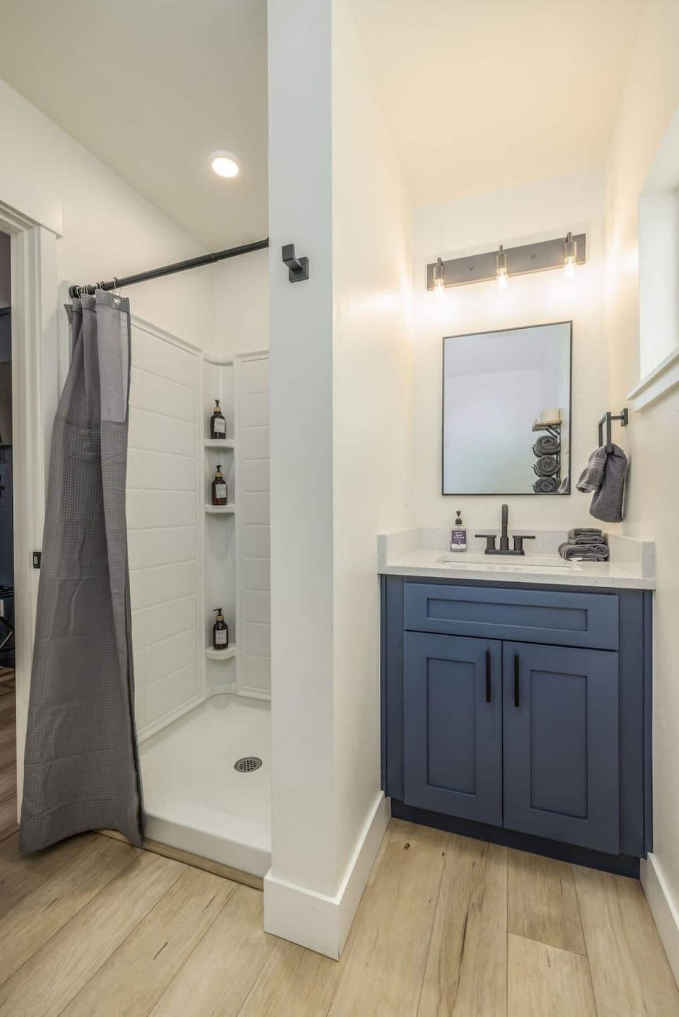 Bathroom with shower, soaps, hair dyer etc .