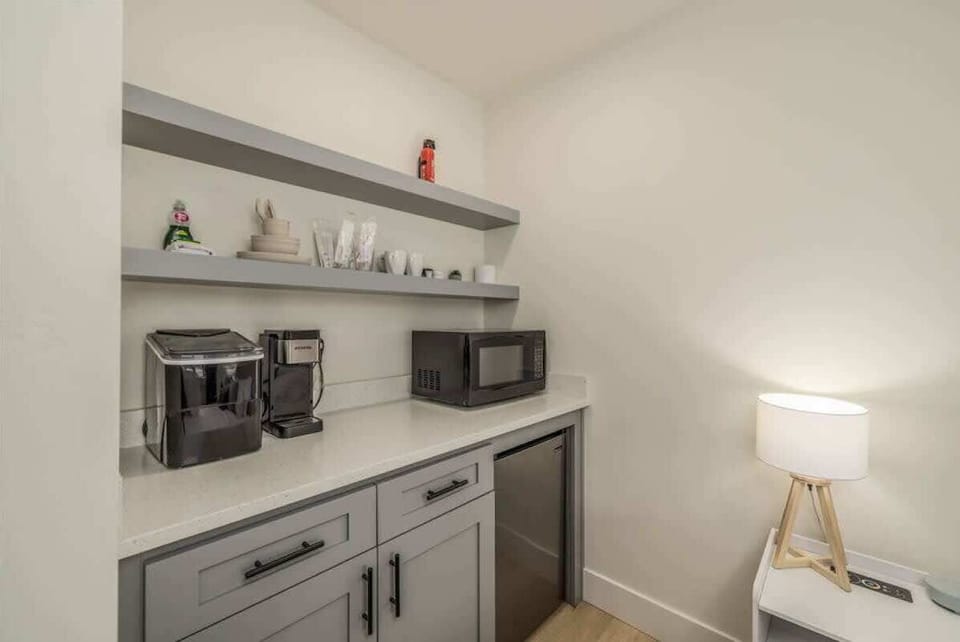 Your apartment has a cute kitchenette with ice maker, microwave, mini fridge, coffee pot, dishes, utensils, and storage 