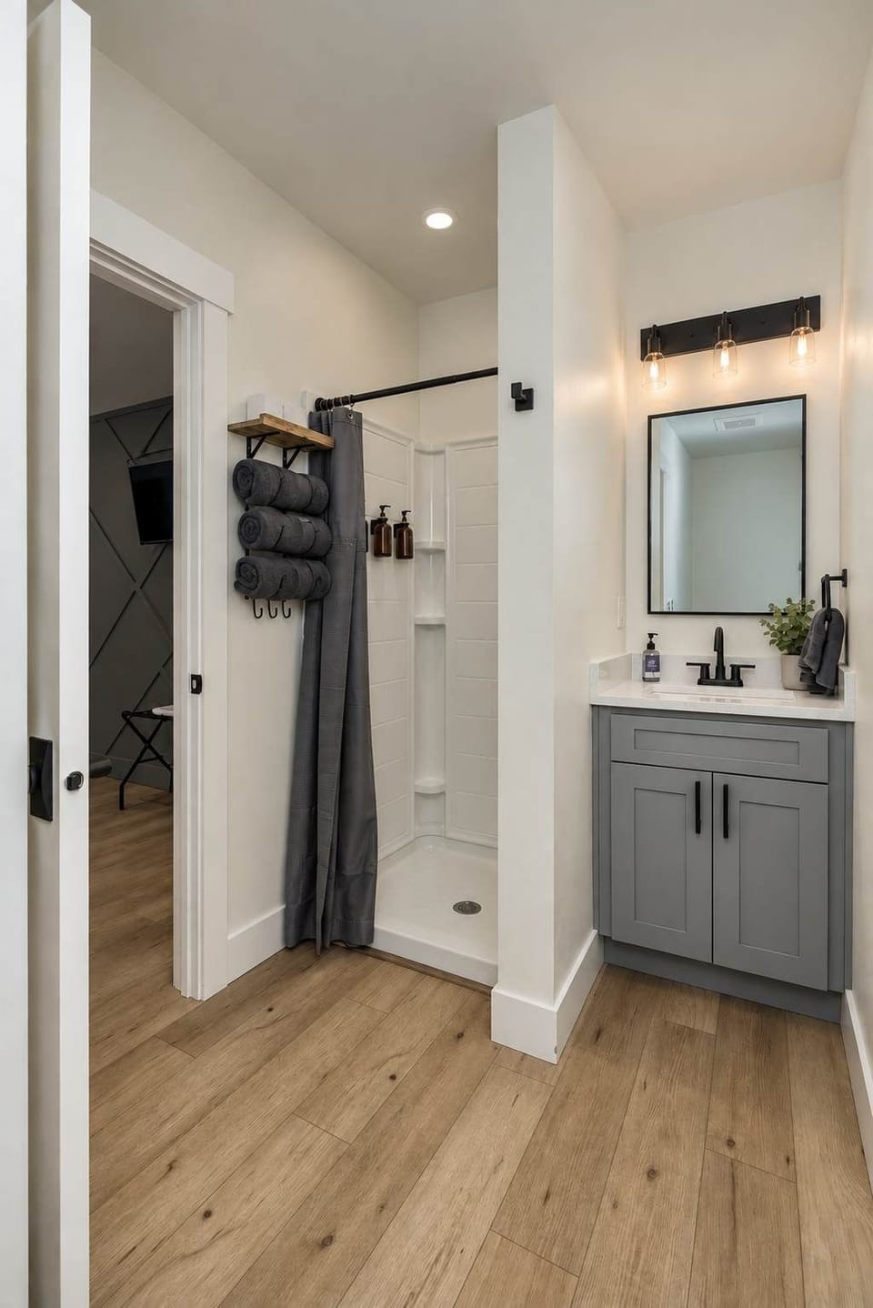 Ensuite bathroom with standing shower, vanity, hair dryer, soaps, towels, and toilet